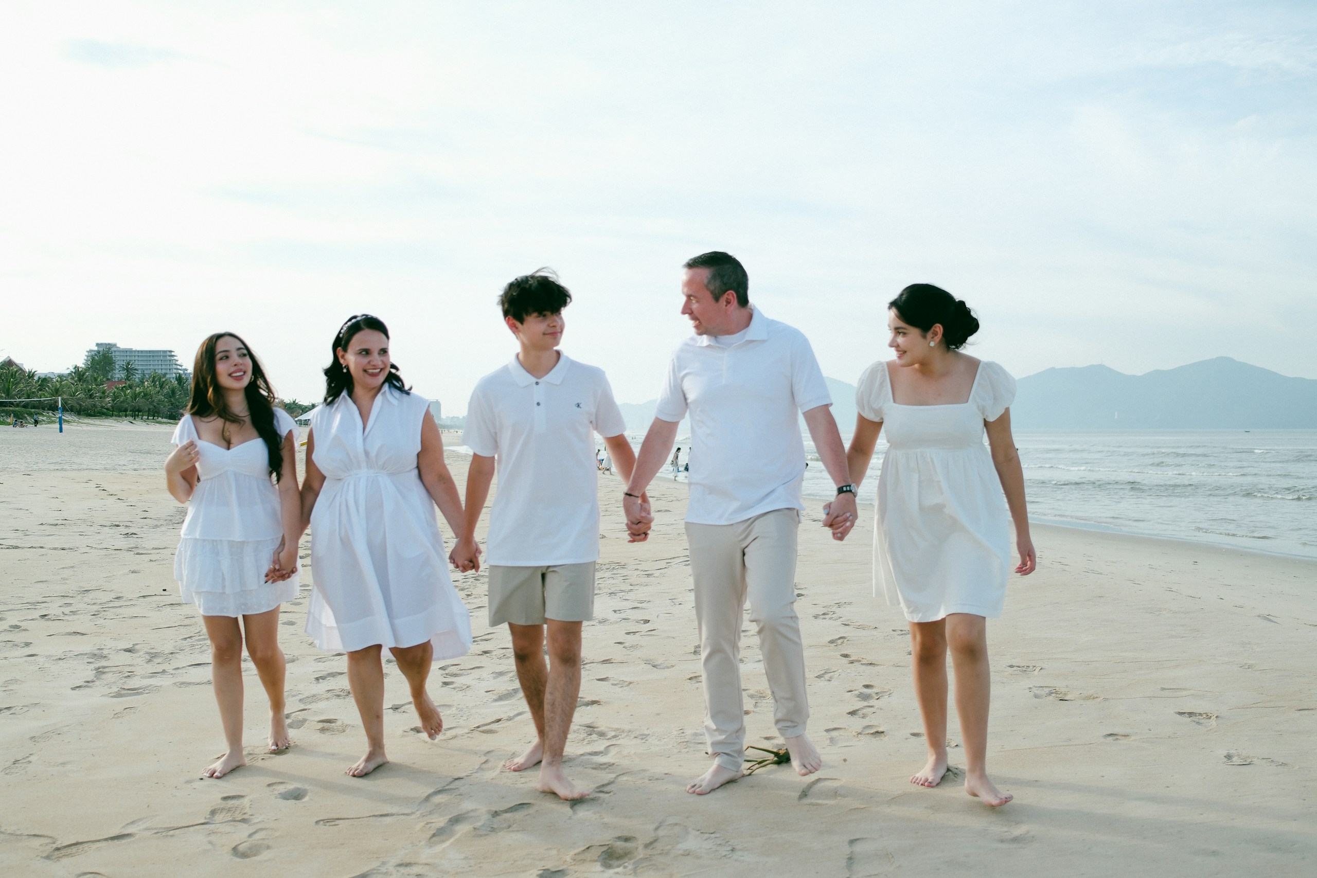 family-walking-hand-in-hand-on-a-sandy-beach-stockpack-unsplash